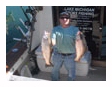Captain John with two fish caught off Chicago on a Playin' Hooky charter